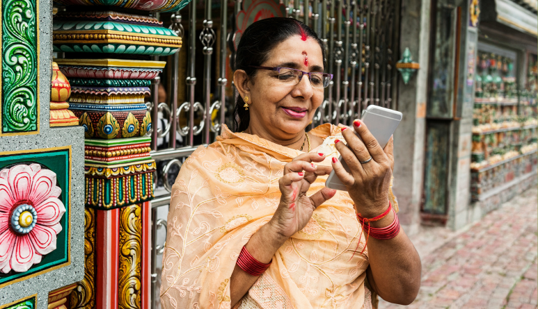 A woman reading a Guidelines devotional on her phone